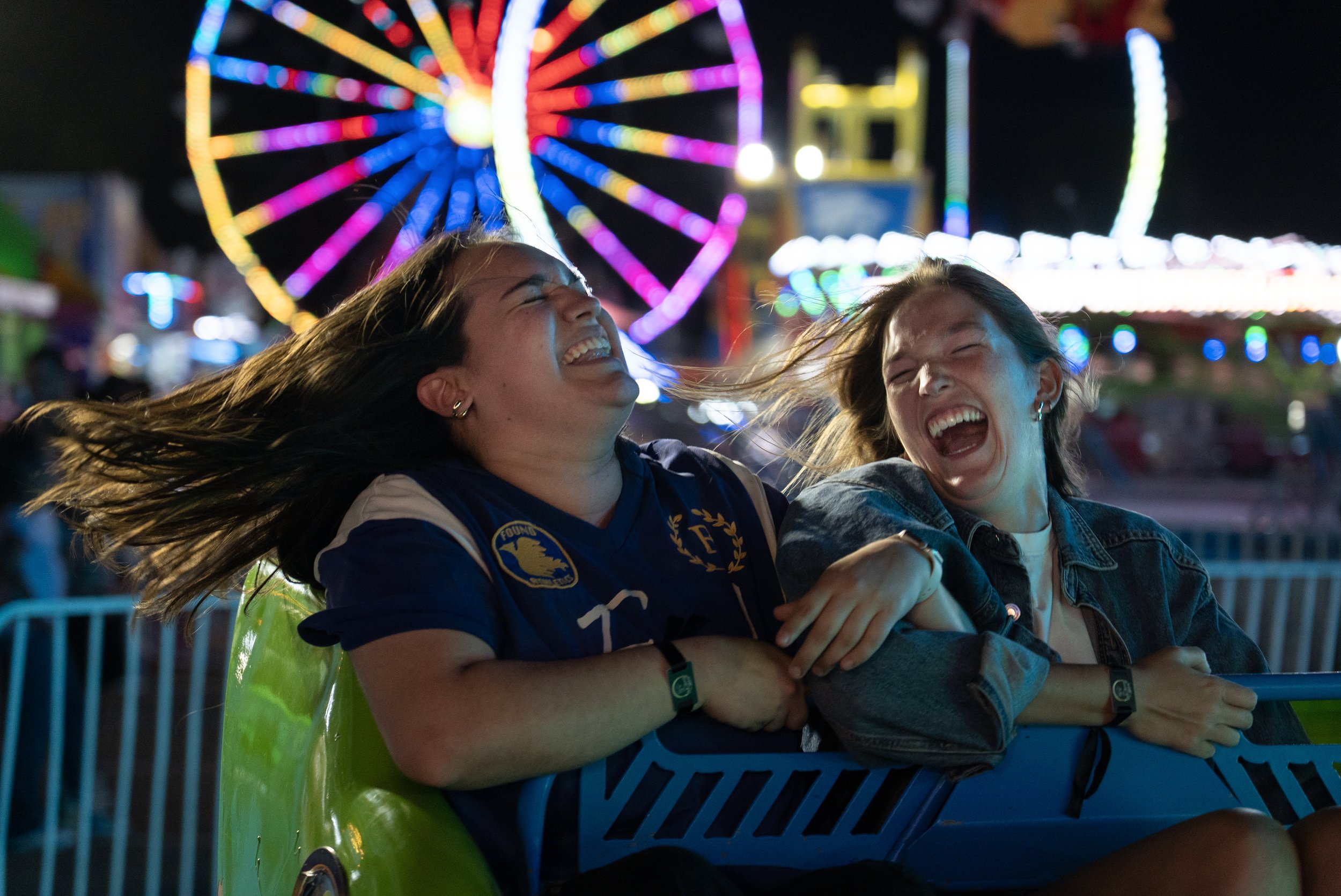  Caitlin Parks and Bailey Dykes laugh while on a ride together at the Mississippi State Fair in Jackson, Miss., on Oct. 13, 2025. [Clarion Ledger] 