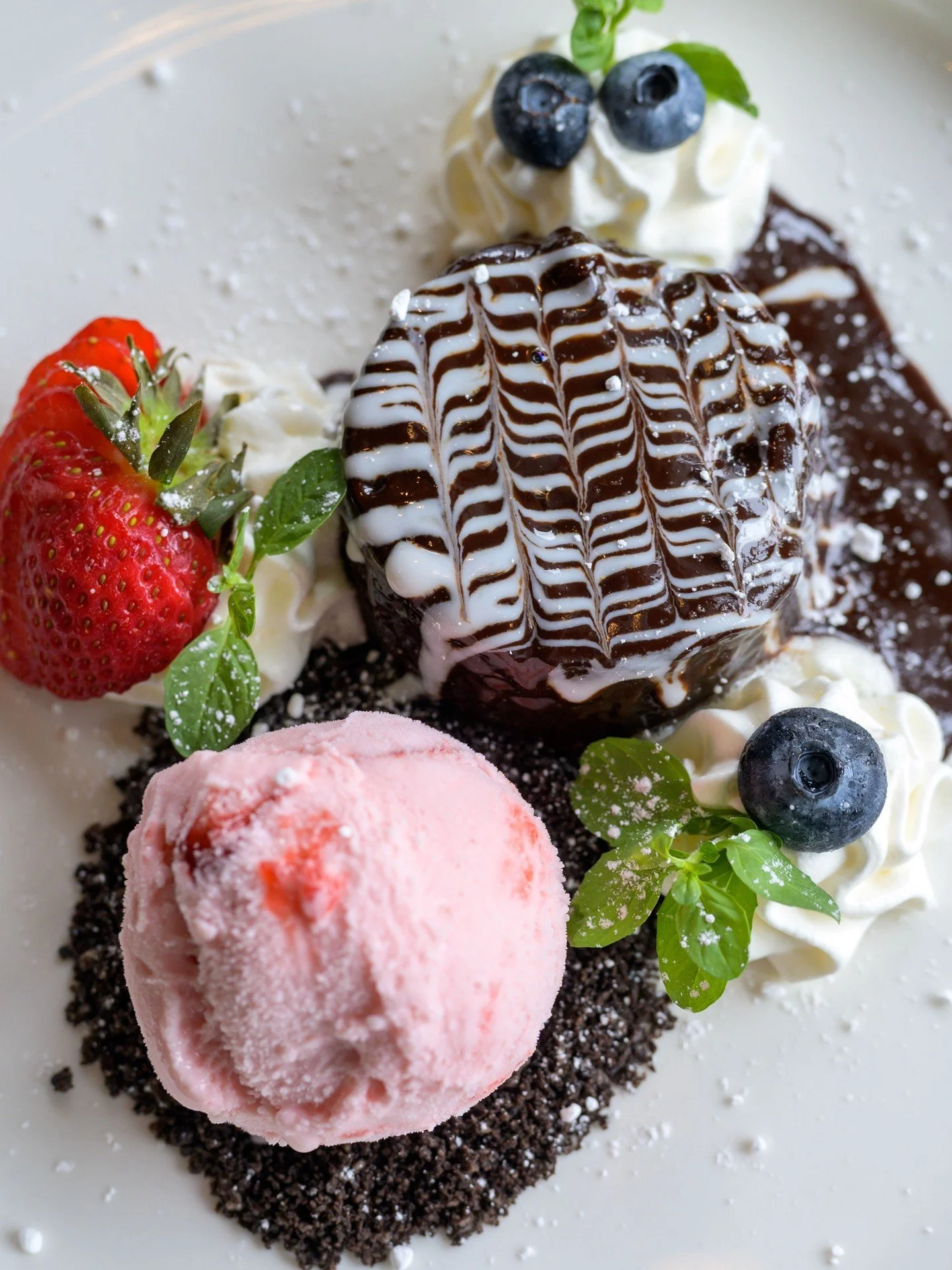 The grand finale you deserve. Our Molten Chocolate Cake is pure indulgence, featuring rich strawberry gelato, Oreo crumbs, and a decadent white chocolate sauce. It's the best way to unwind before concert or a game at Gillette Stadium, so stop by befo