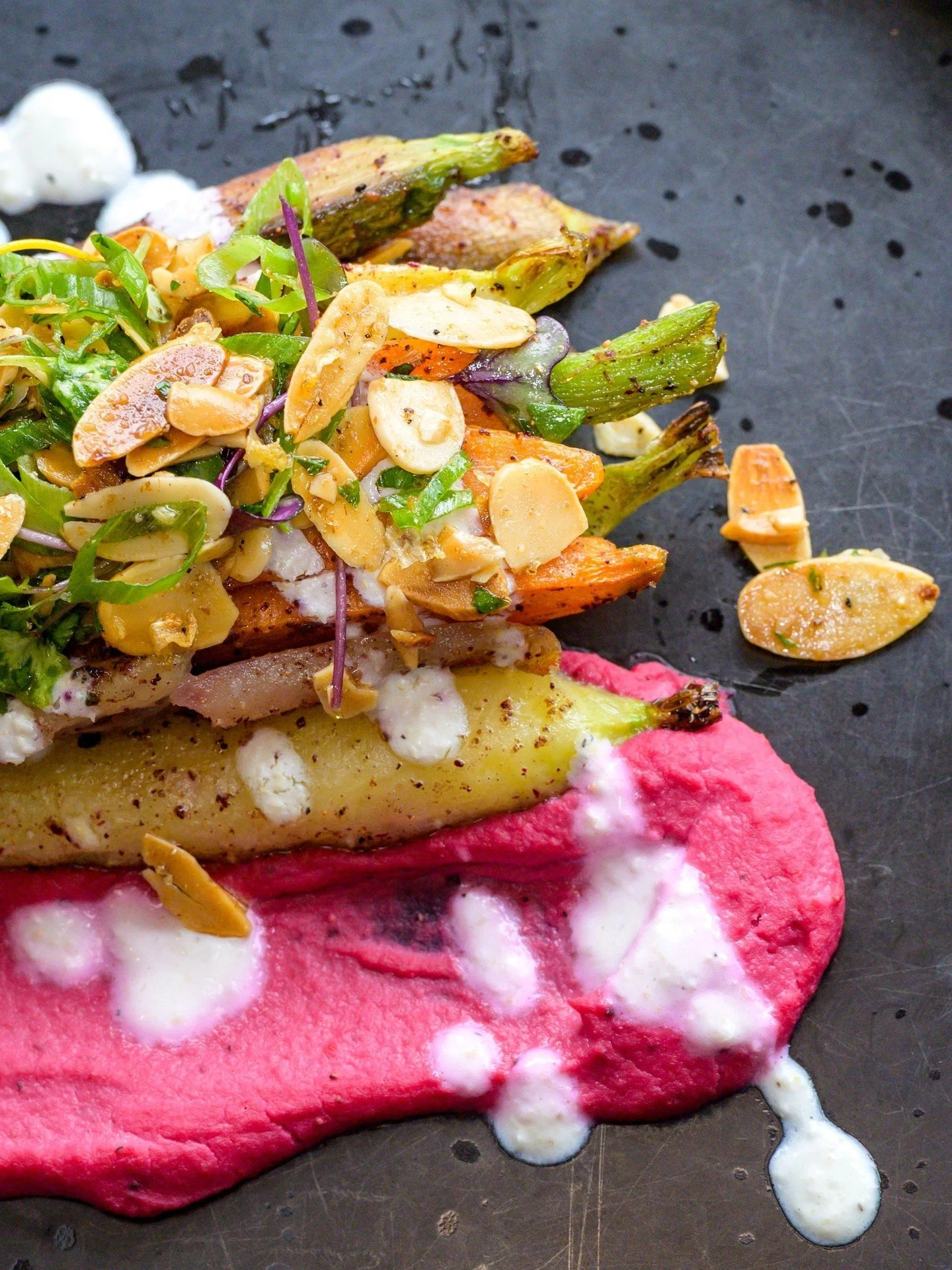 A vibrant symphony of flavors! 🥕 Our Sumac Roasted Carrots are beautifully paired with beet hummus, a crunchy almond gremolata, and creamy garlic &amp; lemon labneh. This flavorful vegetarian dish is a perfect blend of fresh, bold, and satisfying ta