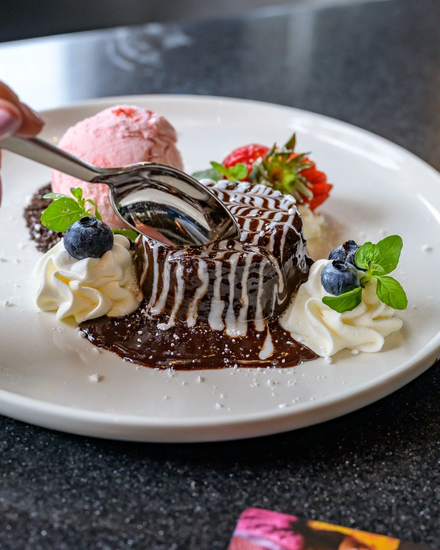 You'll want to save room for this one. Our Molten Chocolate Cake oozes with warm chocolate at the center, paired with strawberry gelato, and fresh berries, you won't be disappointed. This is the kind of treat that makes the whole meal worth it.