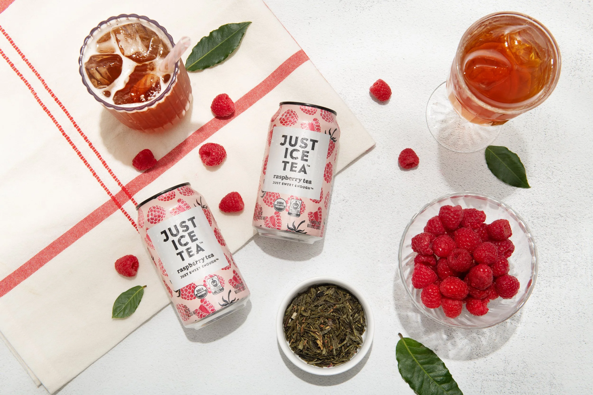 Just Ice Tea lying next to its ingredients for a product photoshoot