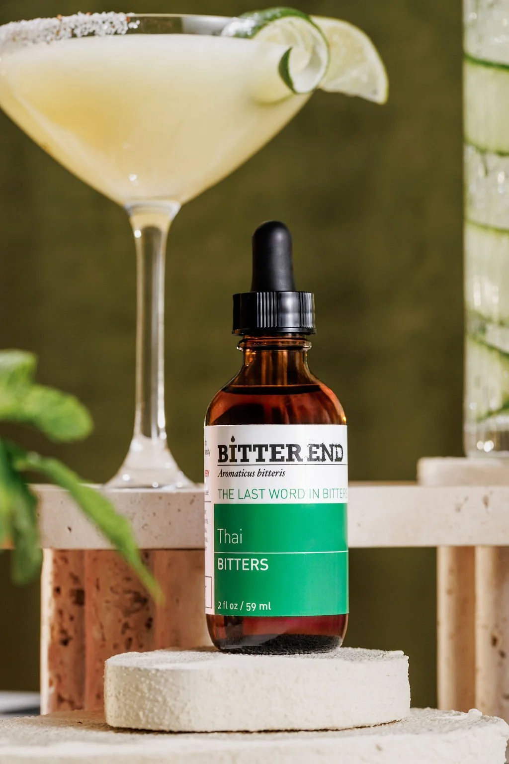 Product photography of bitters in front of a cocktail