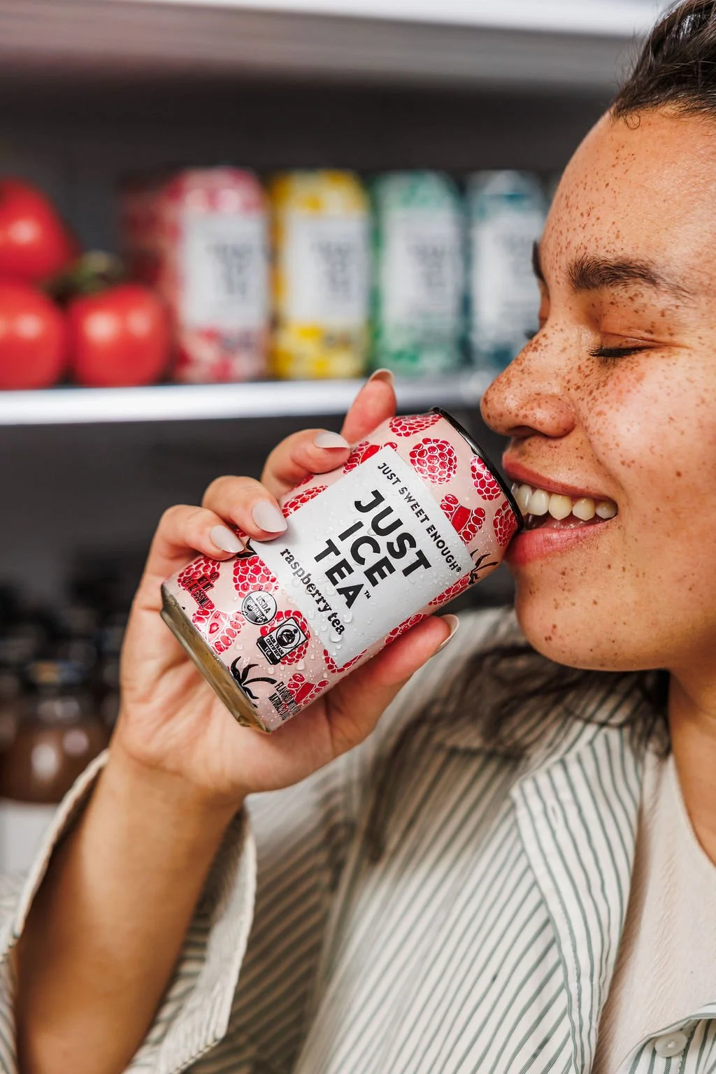 A woman drinking Just Ice Tea during a brand photoshoot