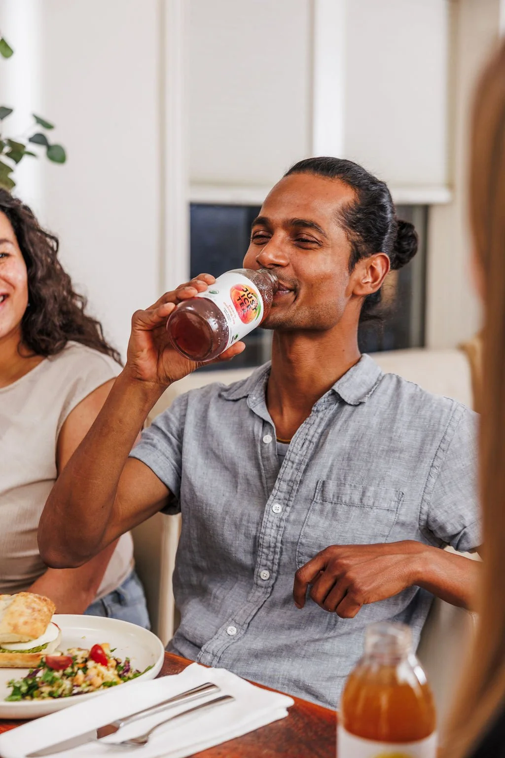 A man drinking Just Ice Tea during a brand photoshoot