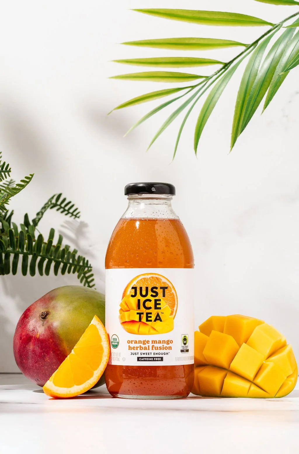 An orange Just Ice Tea in a studio photo backdrop for a brand photoshoot