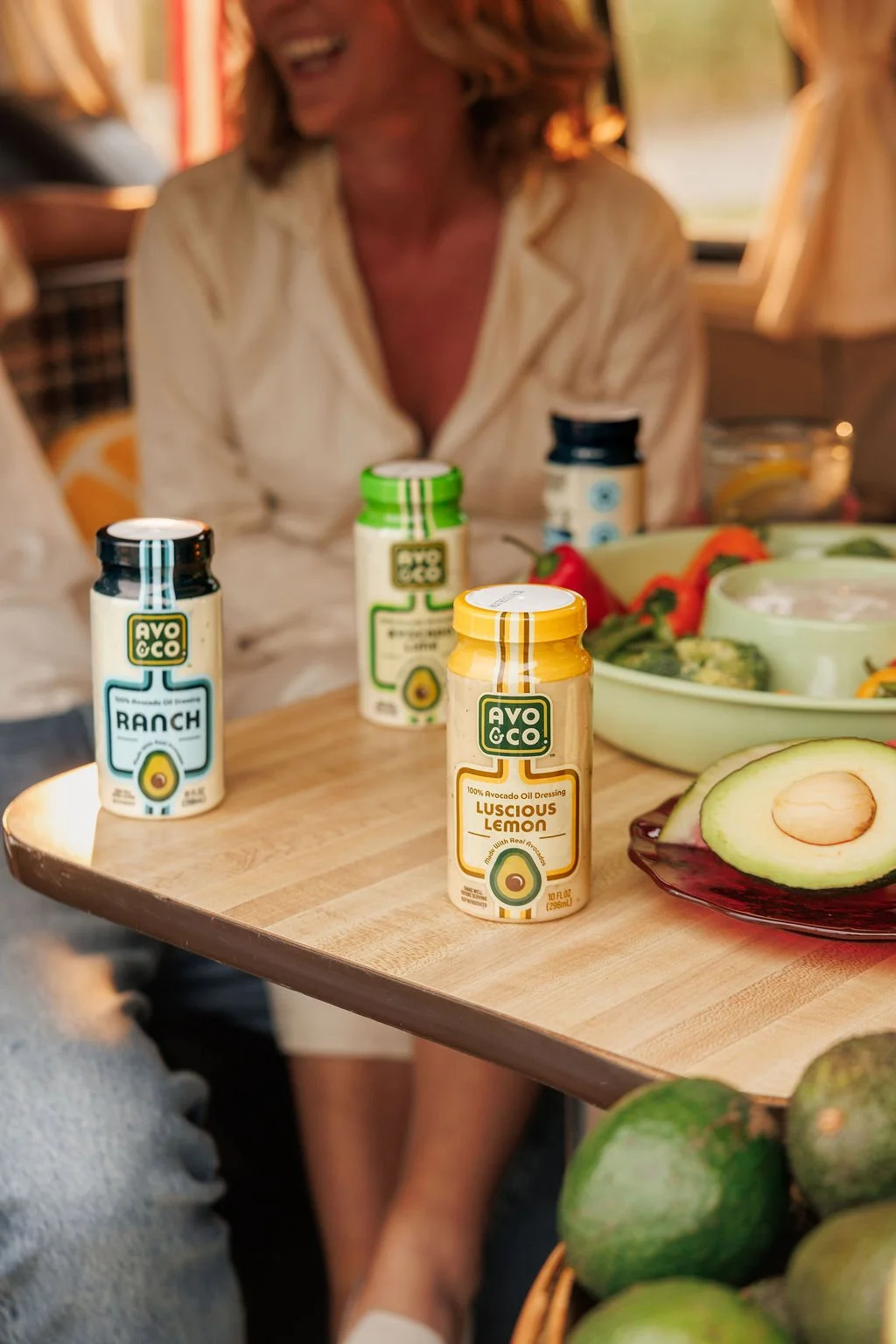 Brand photos showing women sitting behind a product