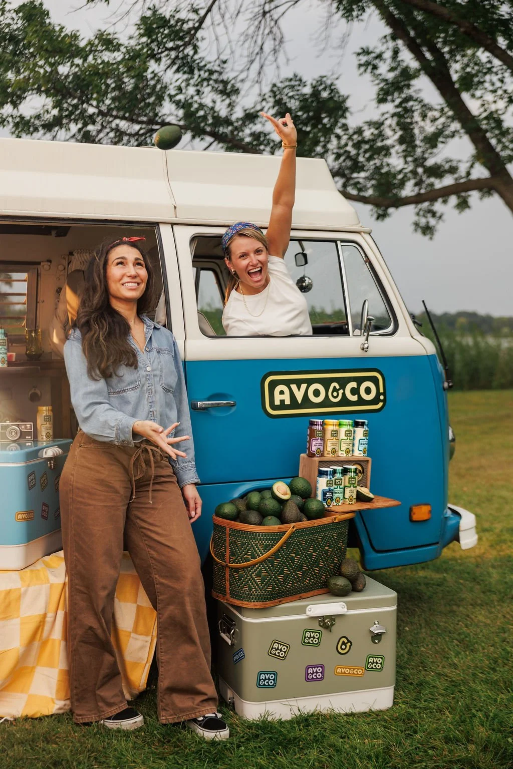 Two women standing with their brand van during a brand photoshoot