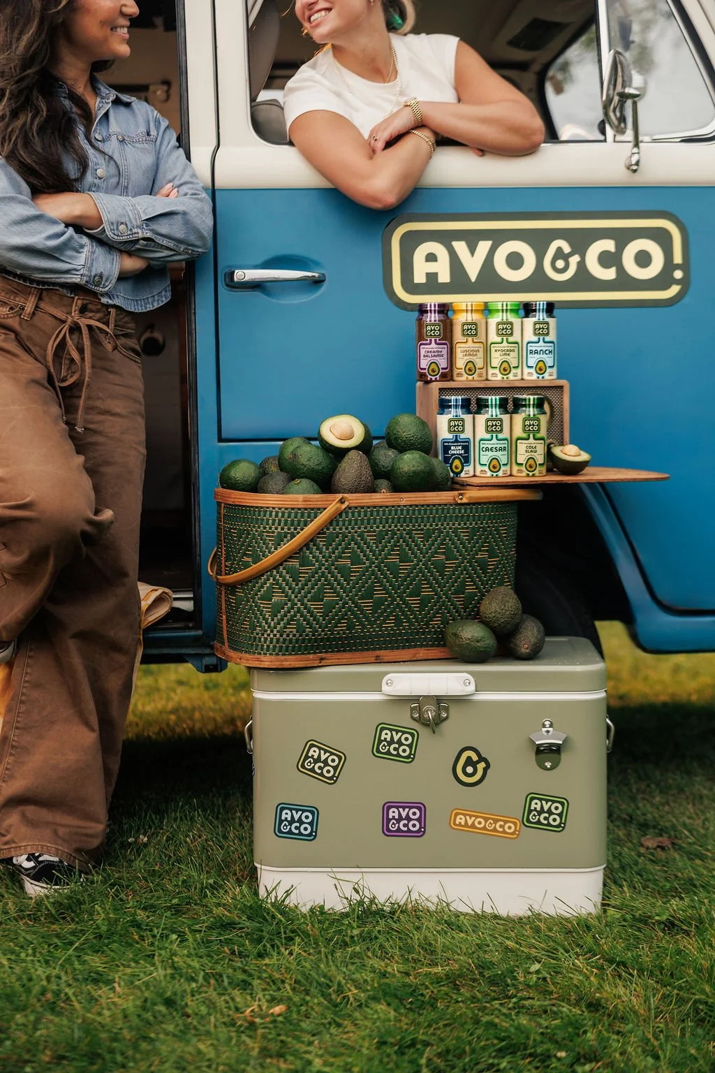 Two women standing with their brand van during a brand photoshoot
