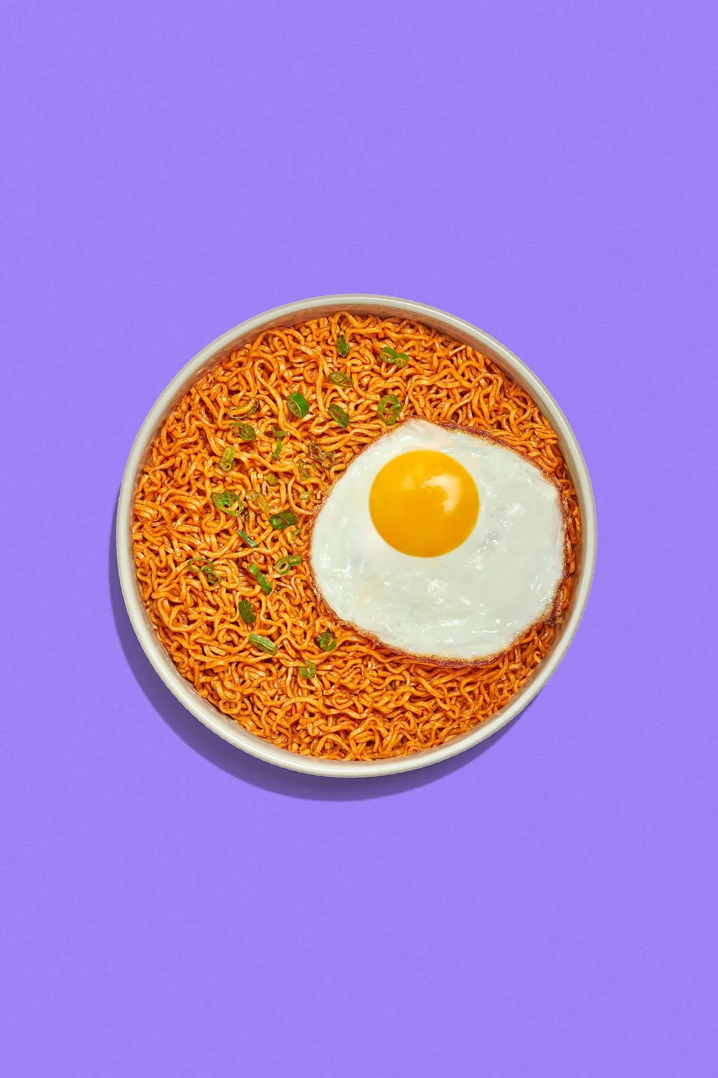 Food photography trends showing a bowl of ramen on a bold backdrop