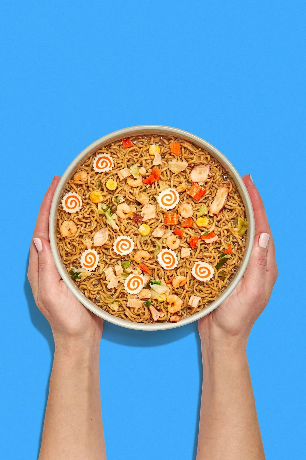 Food photography trends showing a bowl of ramen on a bold backdrop