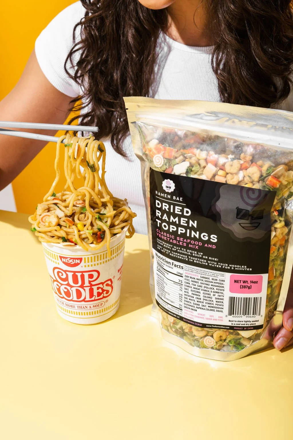 A woman eating ramen for product photography