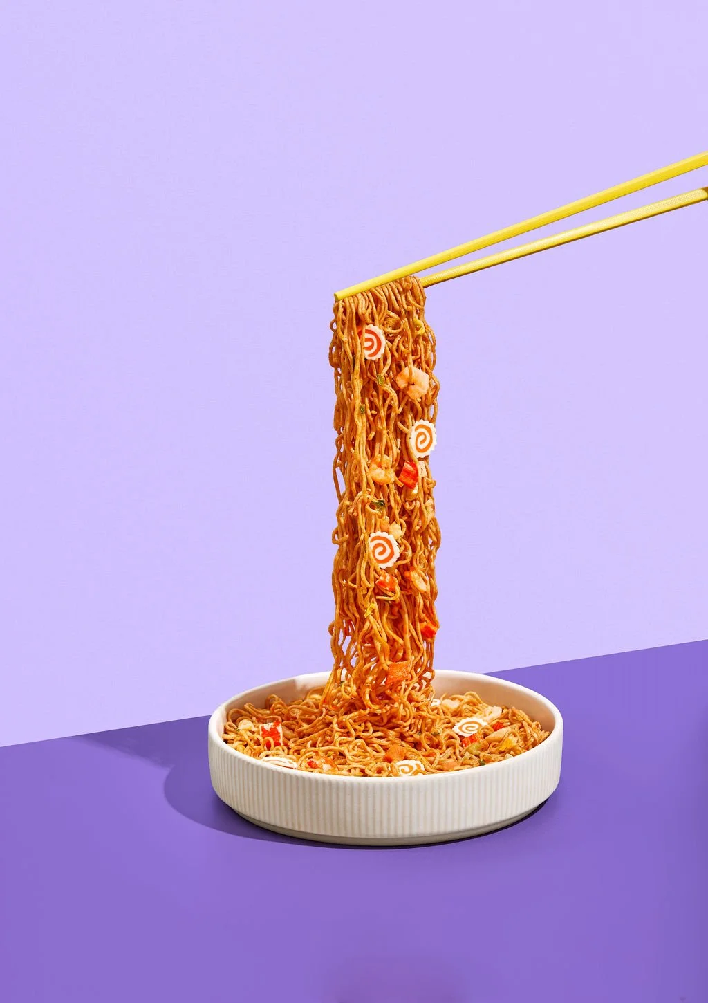 Someone eating ramen with chopsticks for lifestyle product photography