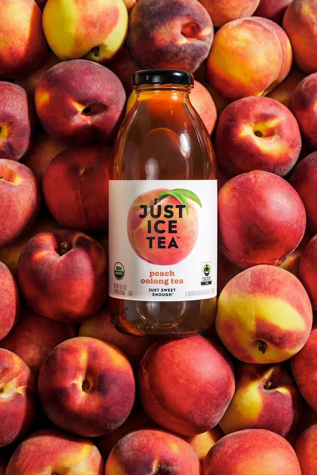 A product image of an iced tea in a bed of fruit