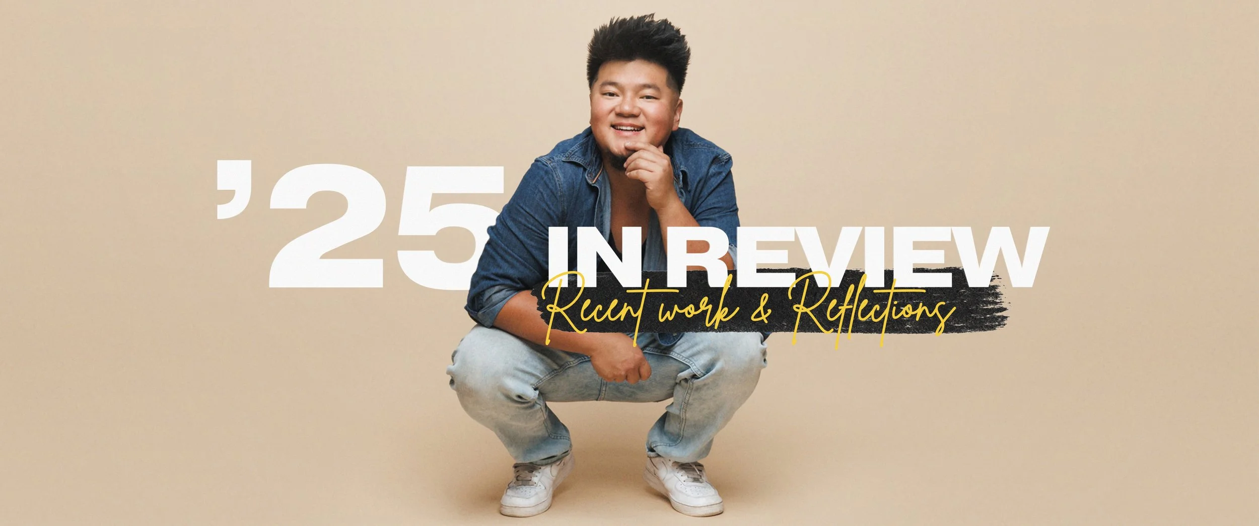 A young man with short black hair smiling and squatting against a beige background, wearing a blue denim shirt, white sneakers, and light jeans. Overlaid text reads '25 IN REVIEW' in large white letters, with smaller yellow cursive text saying 'Recent work & Reflections'.