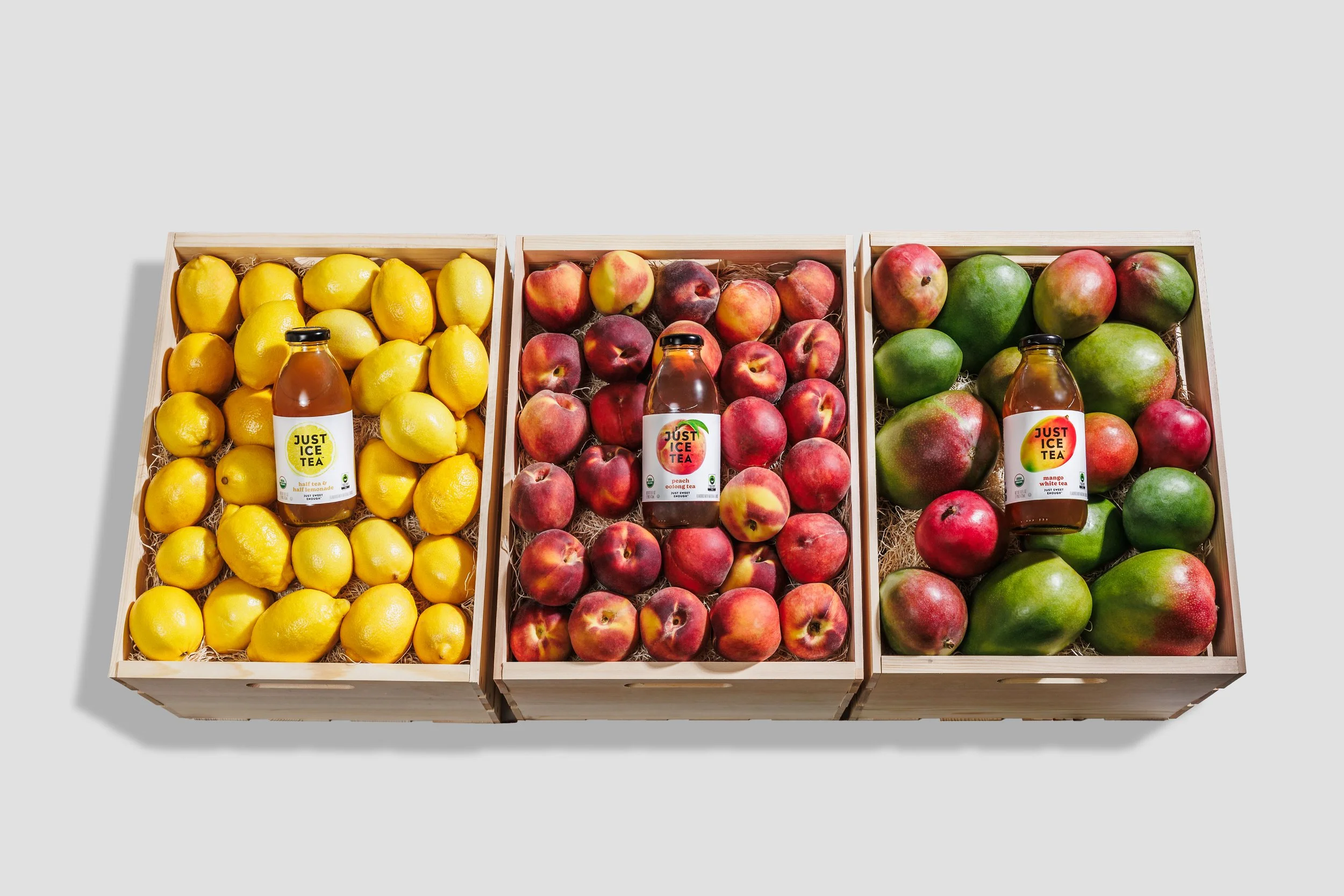 Product photography from a brand photoshoot of iced tea bottles in crates with their flavor of fruit
