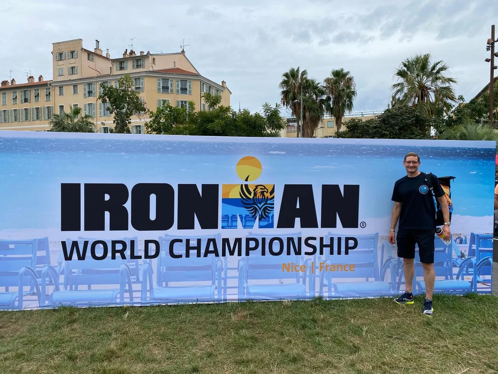 An athlete stands by the official Ironman 70.3 World Championship banner