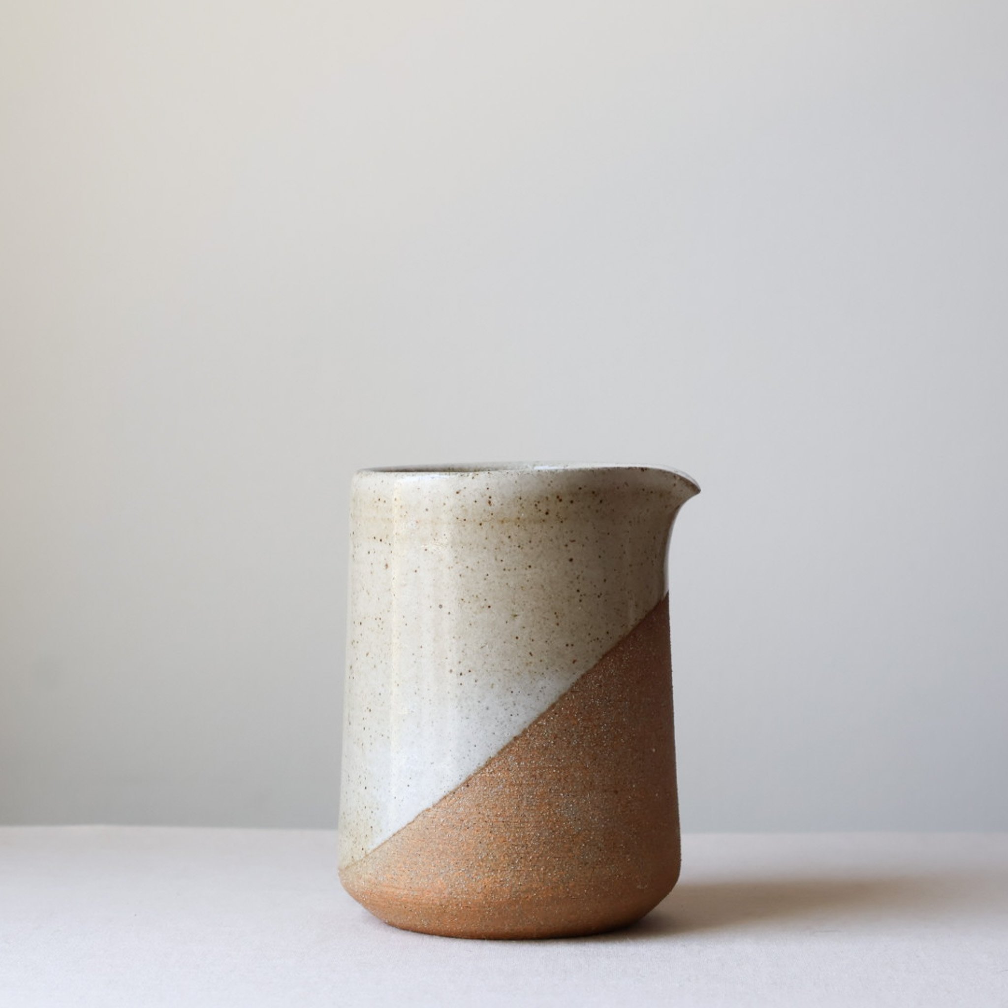 warm-white-angular-handleless-pitcher-2.jpg