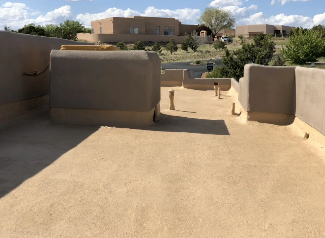 Completed flat roof on an adobe home with parapet walls