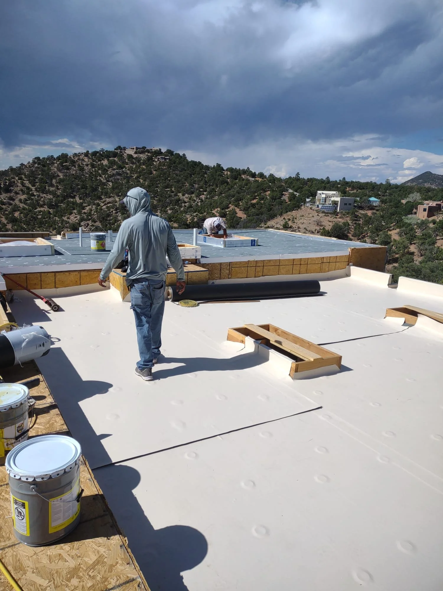 Top Roofing crew installing a new roof membrane in Santa Fe