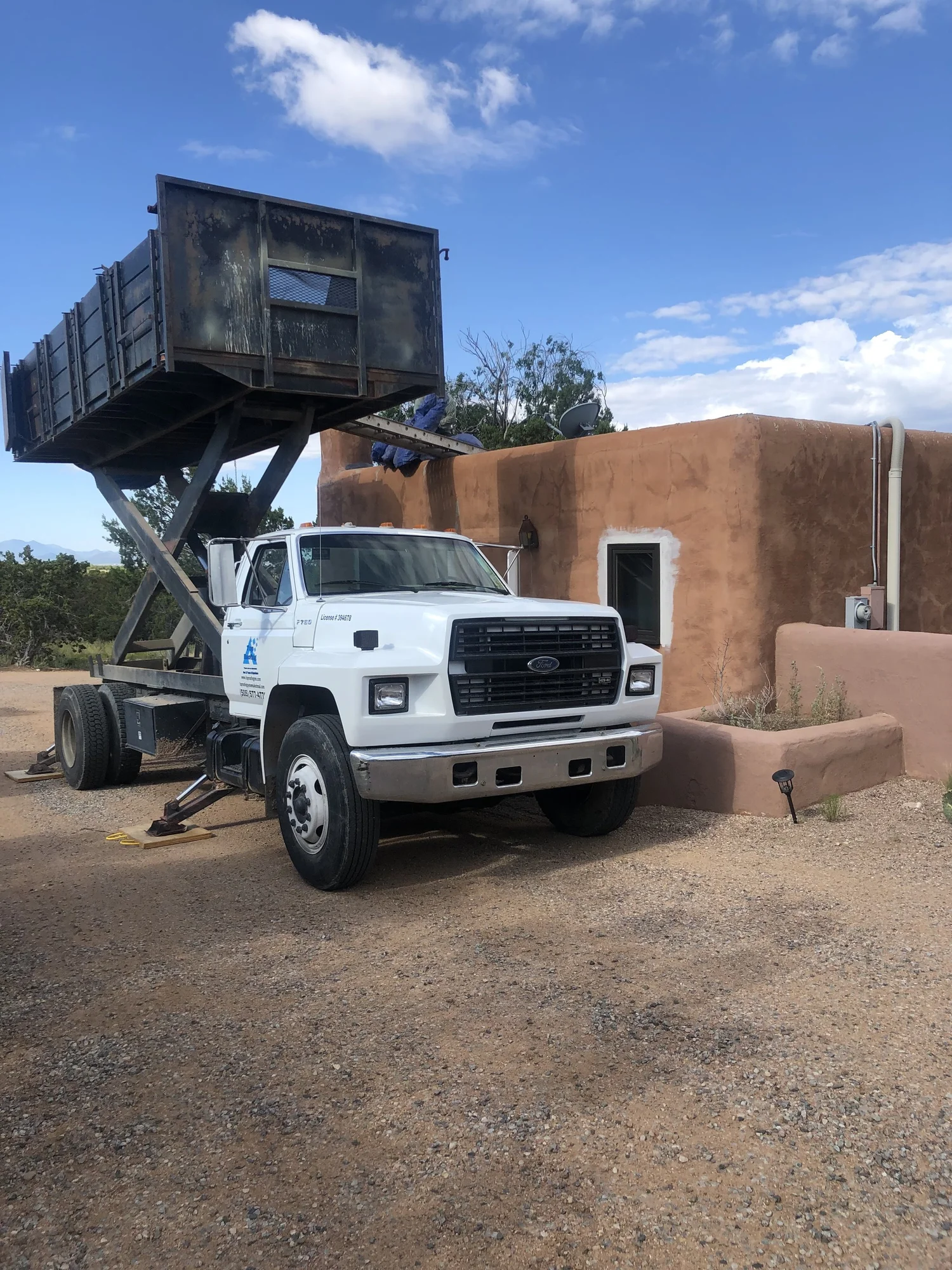 Top Roofing dump truck at a Santa Fe job site