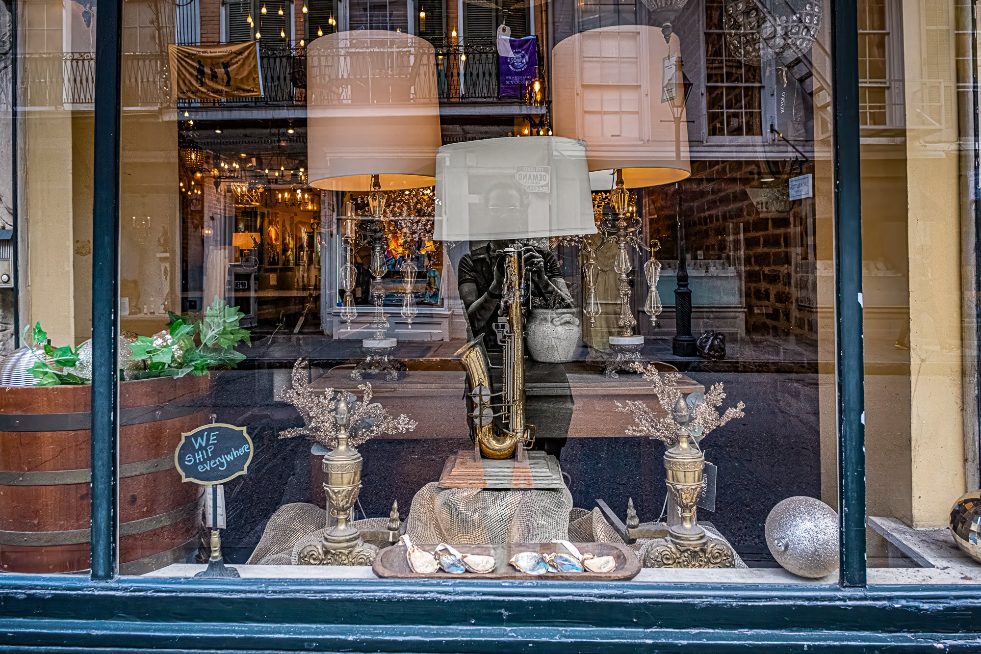A few doors down, I catch a glimpse of myself—reflected in a window, camera up, mid-step, not posing, just observing. That frame reminded me this isn’t just a walk through other people’s stories—I’m in it too. I came to see the city, but the city saw