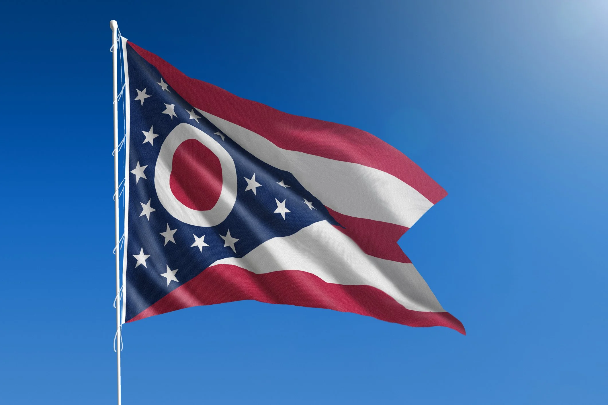 American flag waving in a clear blue sky.