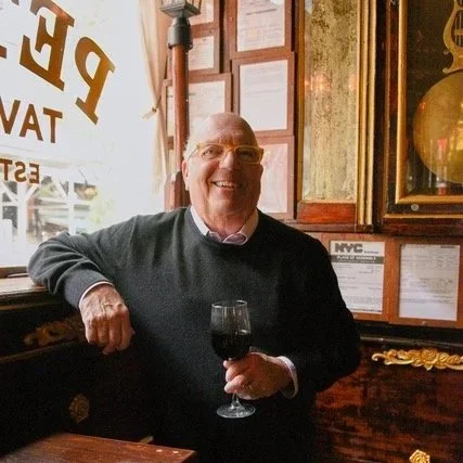 Author E. J. Simon with a glass of wine in Pete's Tavern