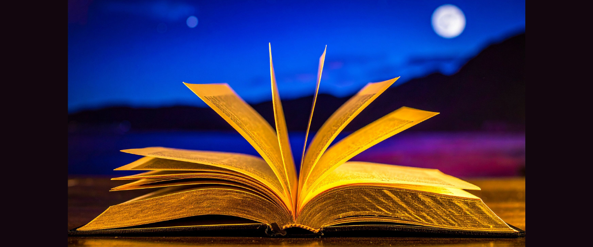 open book with golden pages against a purple and blue landscape with a full moon