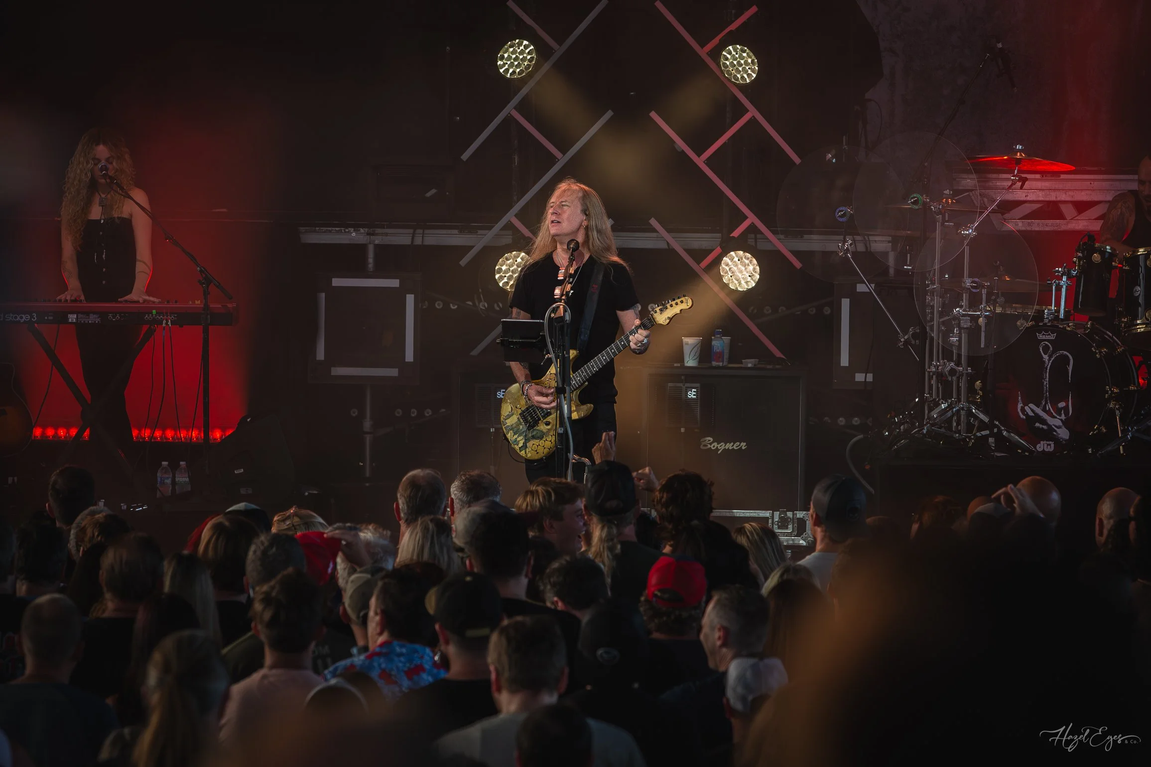 Jerry Cantrell in concert at Michigan Lottery Amphitheatre at Freedom Hill in Sterling Heights, MI on August 16, 2024. Guitarist on stage backlit with bright stage lighting with audience in foreground.