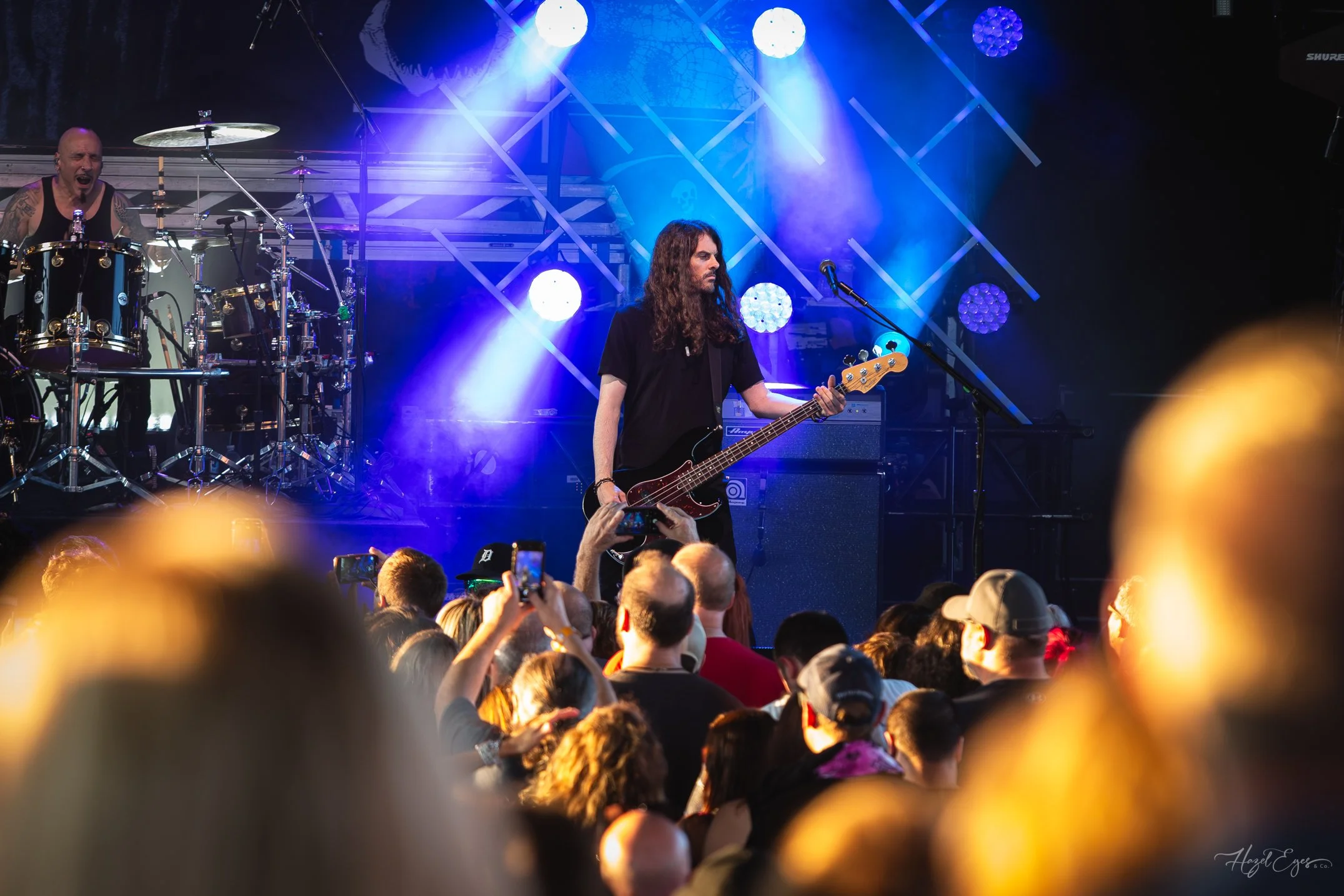 Jerry Cantrell in concert at Michigan Lottery Amphitheatre at Freedom Hill in Sterling Heights, MI on August 16, 2024. Guitarist on stage backlit with bright stage lighting with audience in foreground.