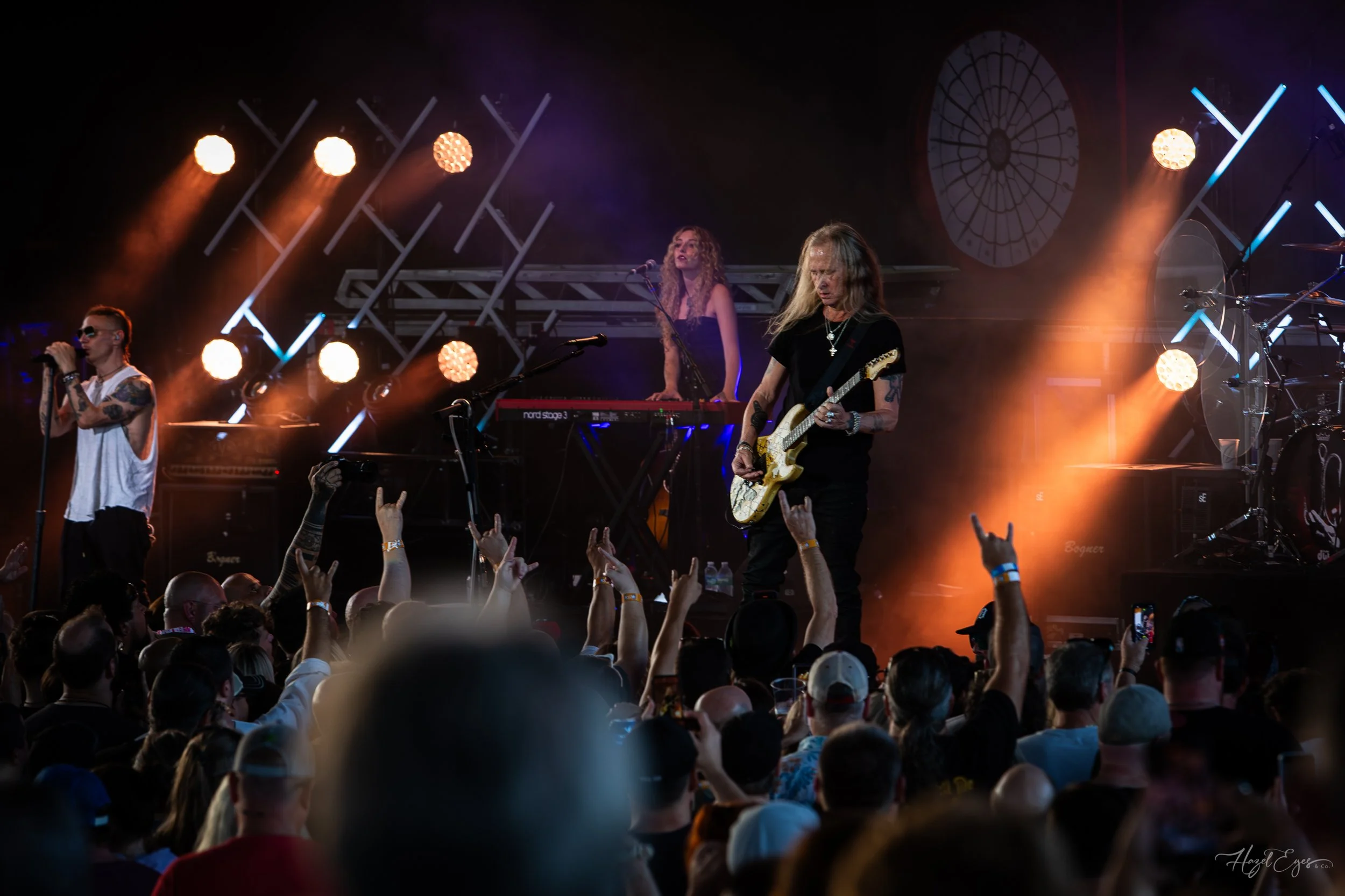 Jerry Cantrell in concert at Michigan Lottery Amphitheatre at Freedom Hill in Sterling Heights, MI on August 16, 2024. Guitarist on stage backlit with bright stage lighting with audience in foreground.