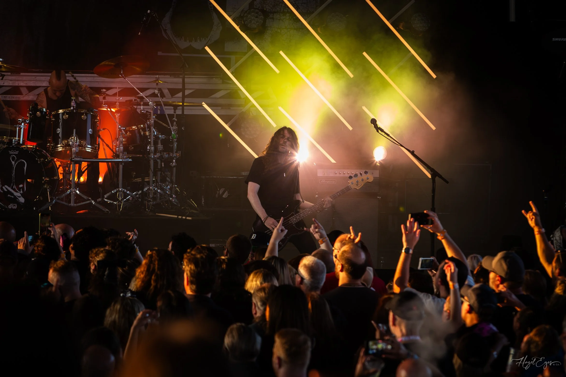 Jerry Cantrell in concert at Michigan Lottery Amphitheatre at Freedom Hill in Sterling Heights, MI on August 16, 2024. Guitarist on stage backlit with bright stage lighting with audience in foreground.