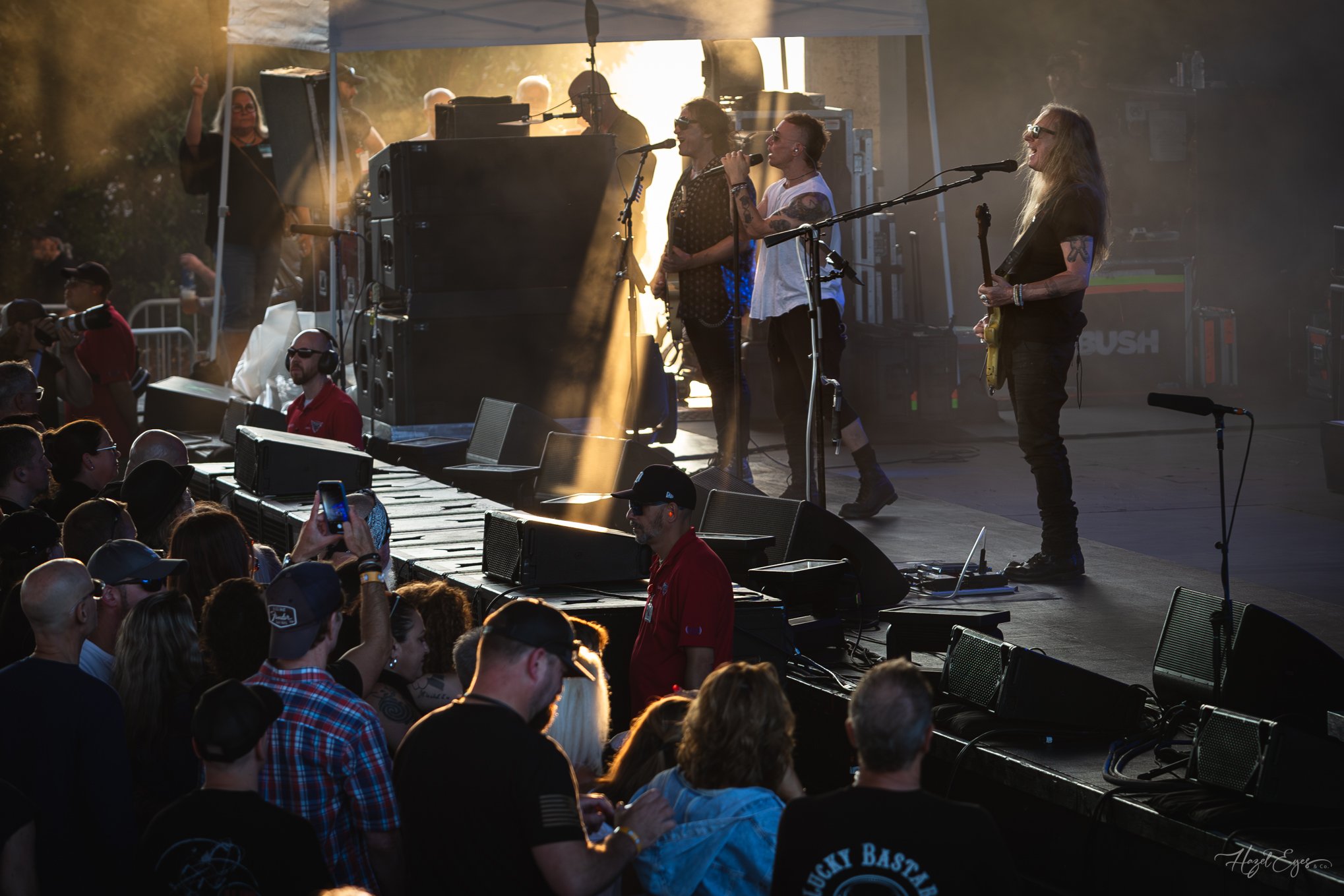 Jerry Cantrell in concert at Michigan Lottery Amphitheatre at Freedom Hill in Sterling Heights, MI on August 16, 2024. Guitarist on stage backlit with bright stage lighting with rays of sunlight shining on stage from the side.
