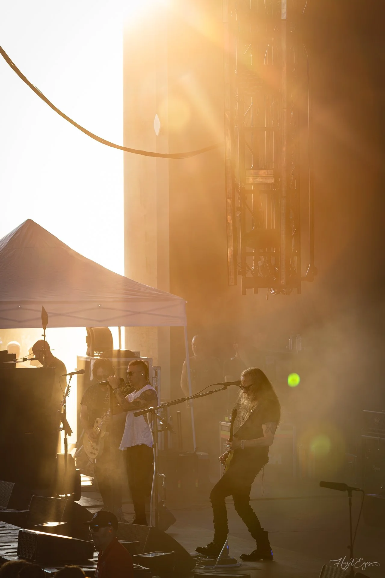 Jerry Cantrell in concert at Michigan Lottery Amphitheatre at Freedom Hill in Sterling Heights, MI on August 16, 2024. Guitarist on stage backlit with bright stage lighting with sunburst lighting from the side of the stage.