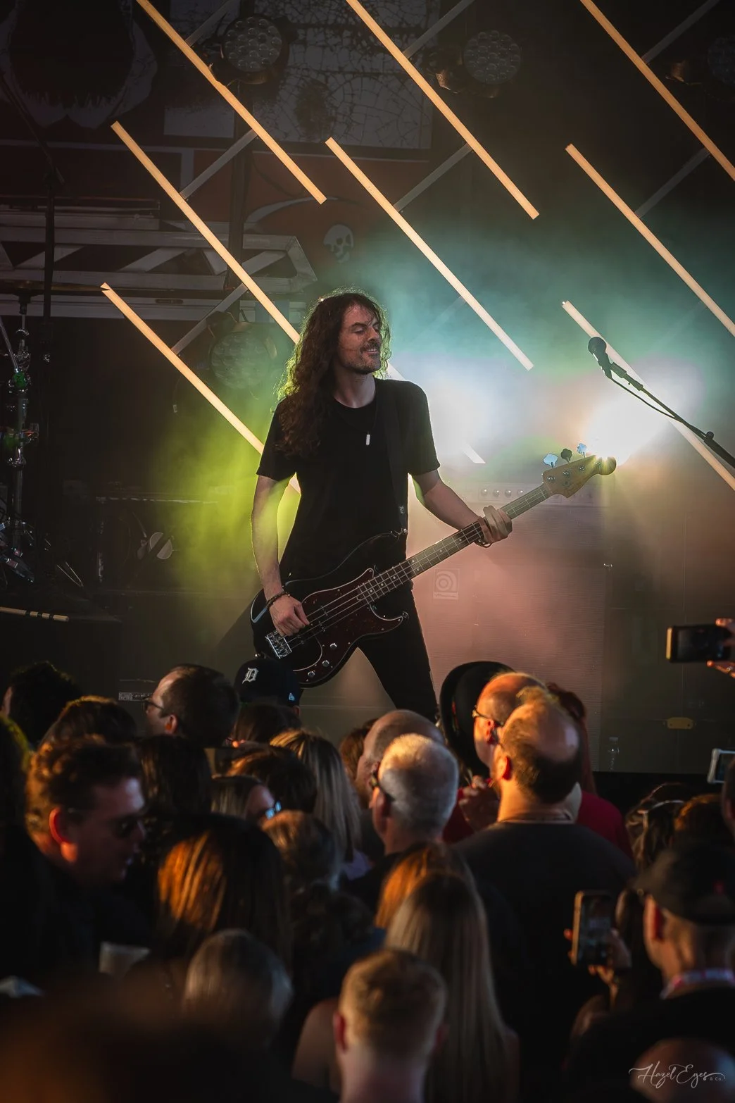 Jerry Cantrell in concert at Michigan Lottery Amphitheatre at Freedom Hill in Sterling Heights, MI on August 16, 2024. Guitarist on stage backlit with bright stage lighting with audience in foreground.