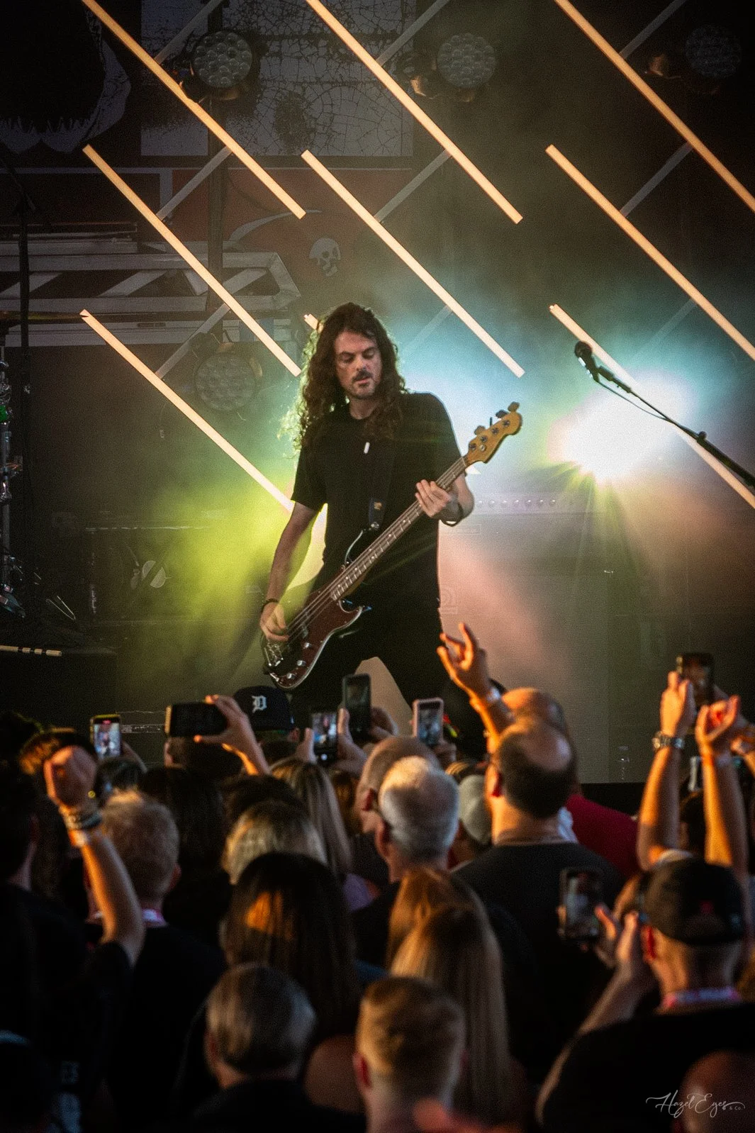 Jerry Cantrell in concert at Michigan Lottery Amphitheatre at Freedom Hill in Sterling Heights, MI on August 16, 2024. Guitarist on stage backlit with bright stage lighting with audience in foreground.