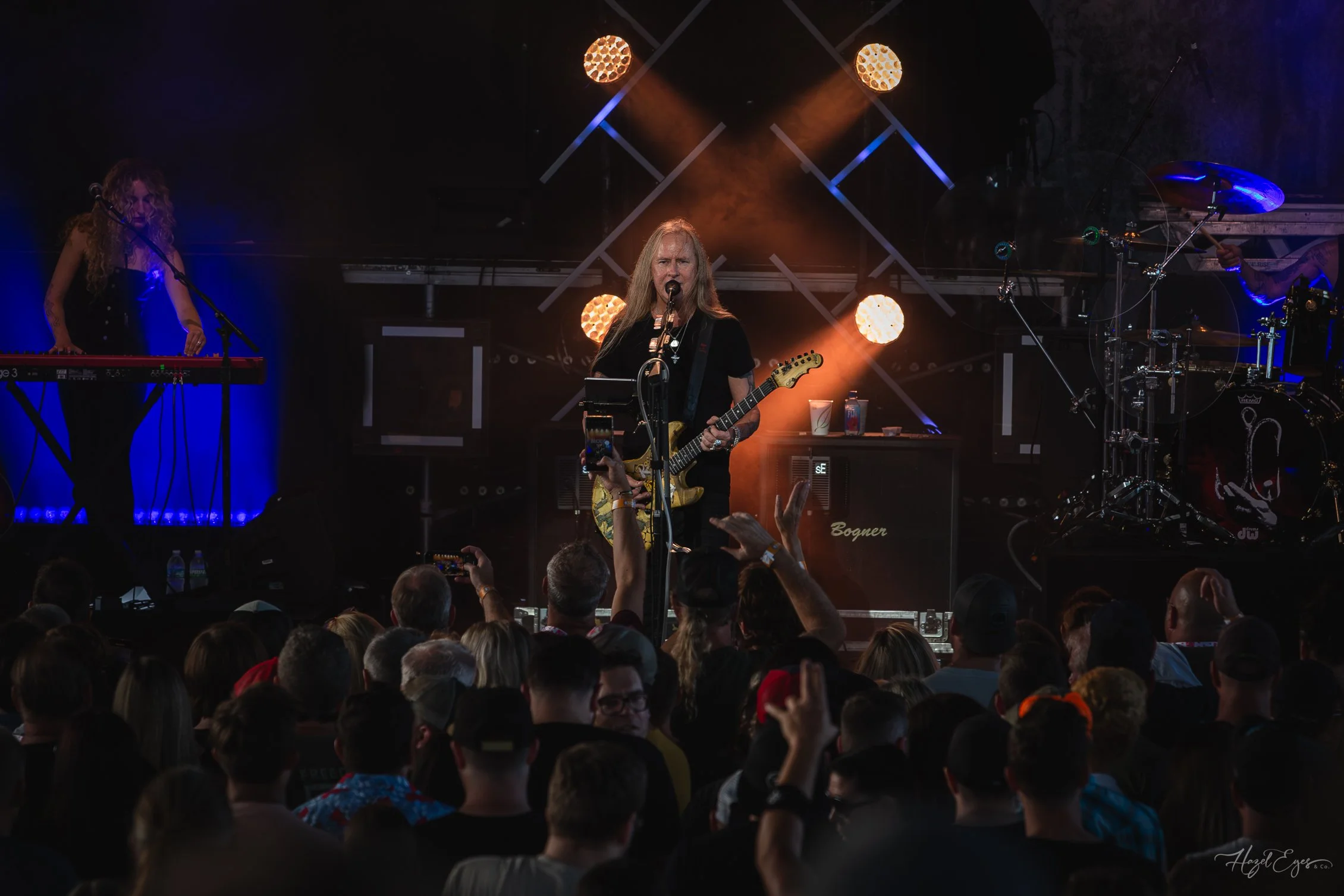 Jerry Cantrell in concert at Michigan Lottery Amphitheatre at Freedom Hill in Sterling Heights, MI on August 16, 2024. Guitarist on stage backlit with bright stage lighting with audience in foreground.
