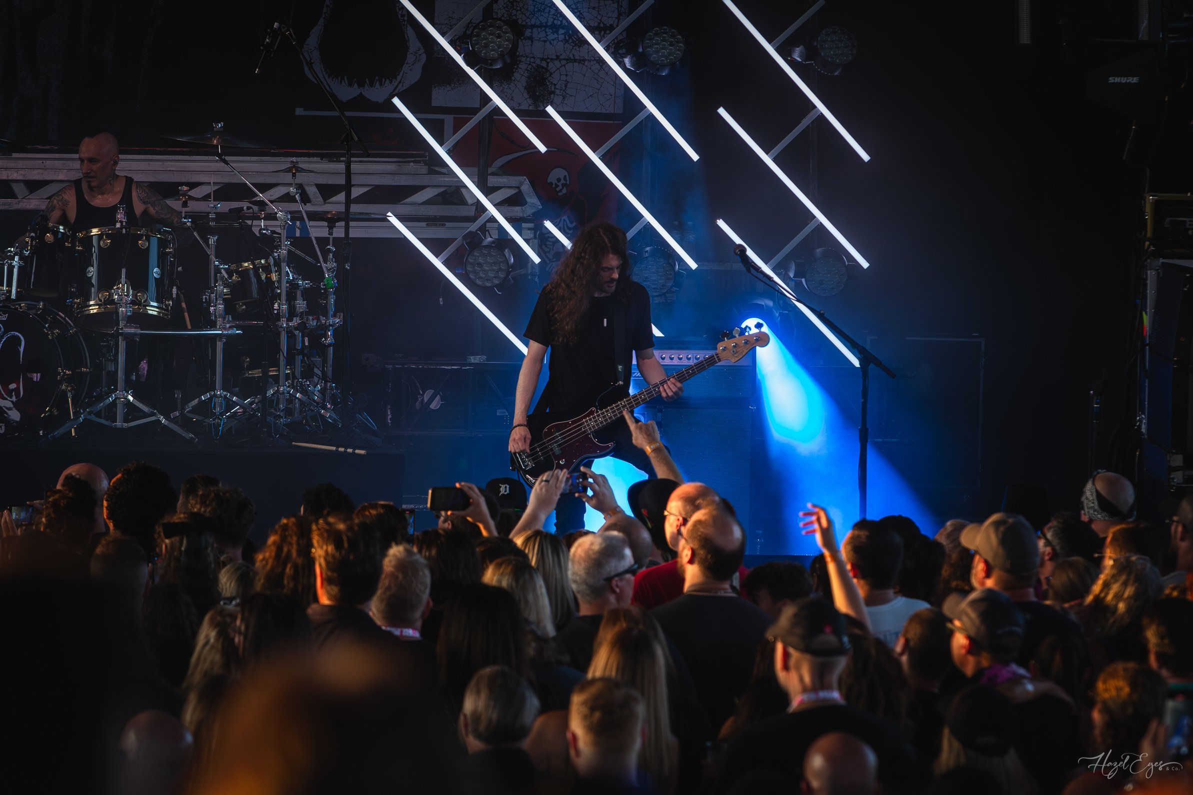 Jerry Cantrell in concert at Michigan Lottery Amphitheatre at Freedom Hill in Sterling Heights, MI on August 16, 2024. Guitarist on stage backlit with bright stage lighting with audience in foreground.
