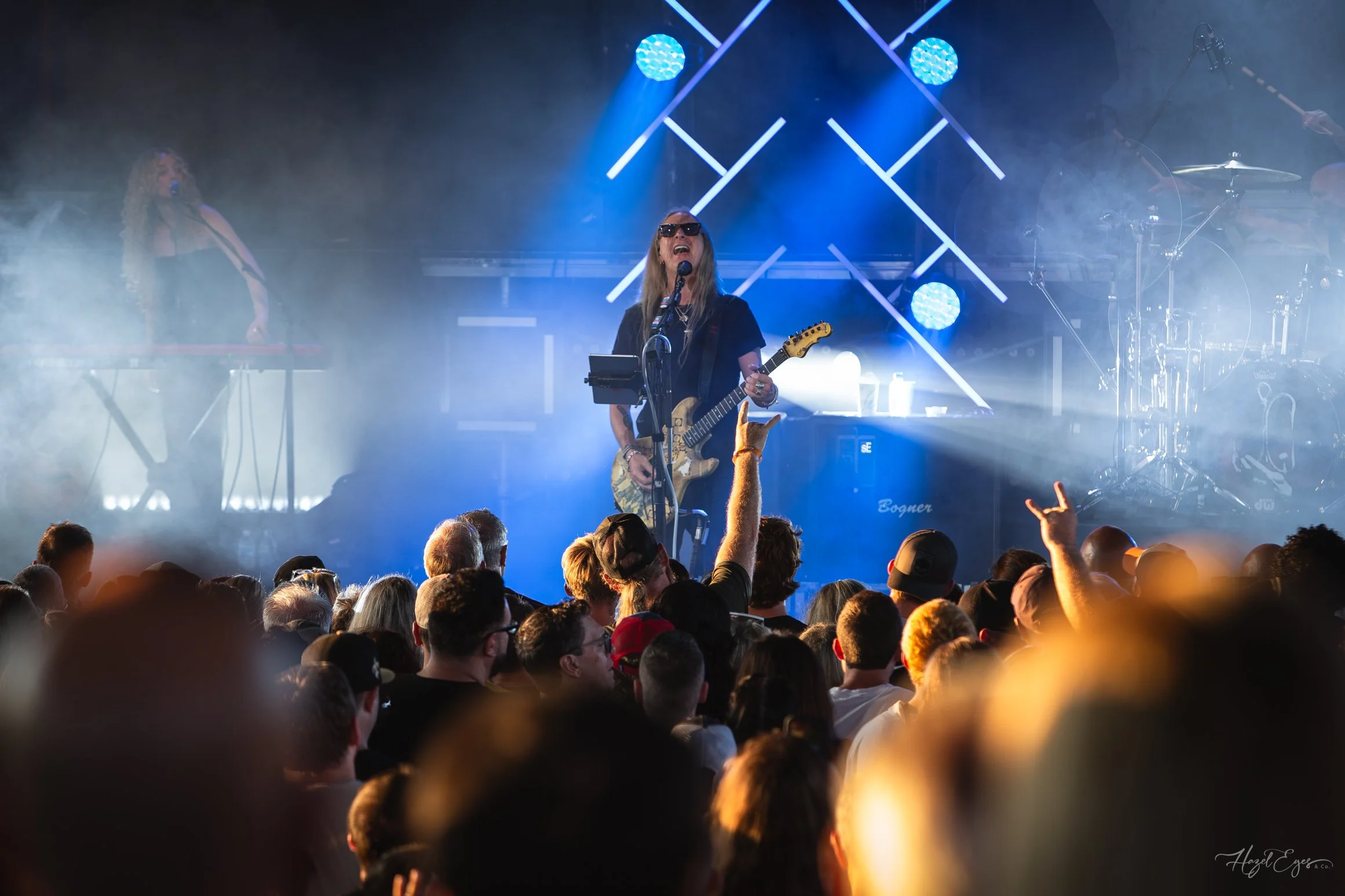 Jerry Cantrell in concert at Michigan Lottery Amphitheatre at Freedom Hill in Sterling Heights, MI on August 16, 2024. Guitarist on stage backlit with bright stage lighting with audience in foreground.
