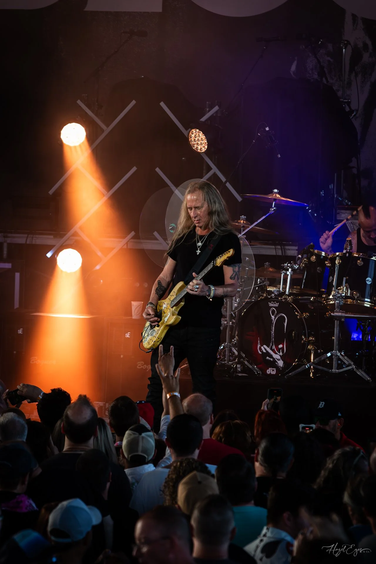 Jerry Cantrell in concert at Michigan Lottery Amphitheatre at Freedom Hill in Sterling Heights, MI on August 16, 2024. Guitarist on stage backlit with bright stage lighting with audience in foreground.