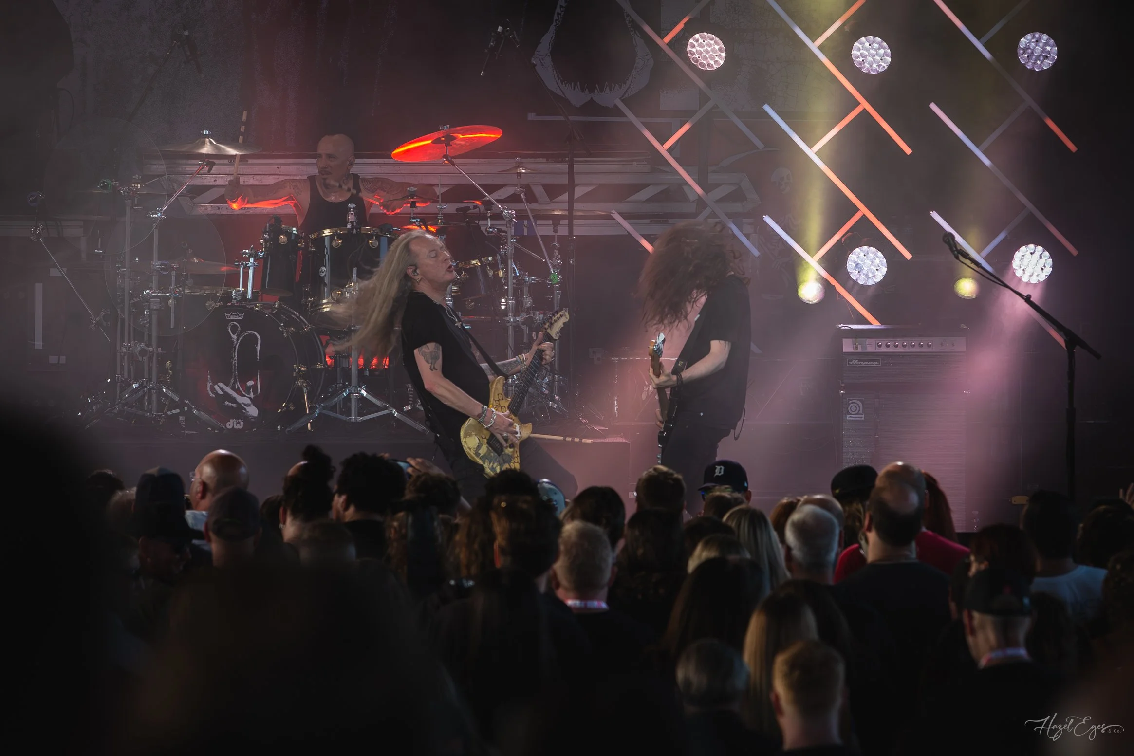 Jerry Cantrell in concert at Michigan Lottery Amphitheatre at Freedom Hill in Sterling Heights, MI on August 16, 2024. Guitarist on stage backlit with bright stage lighting with audience in foreground.