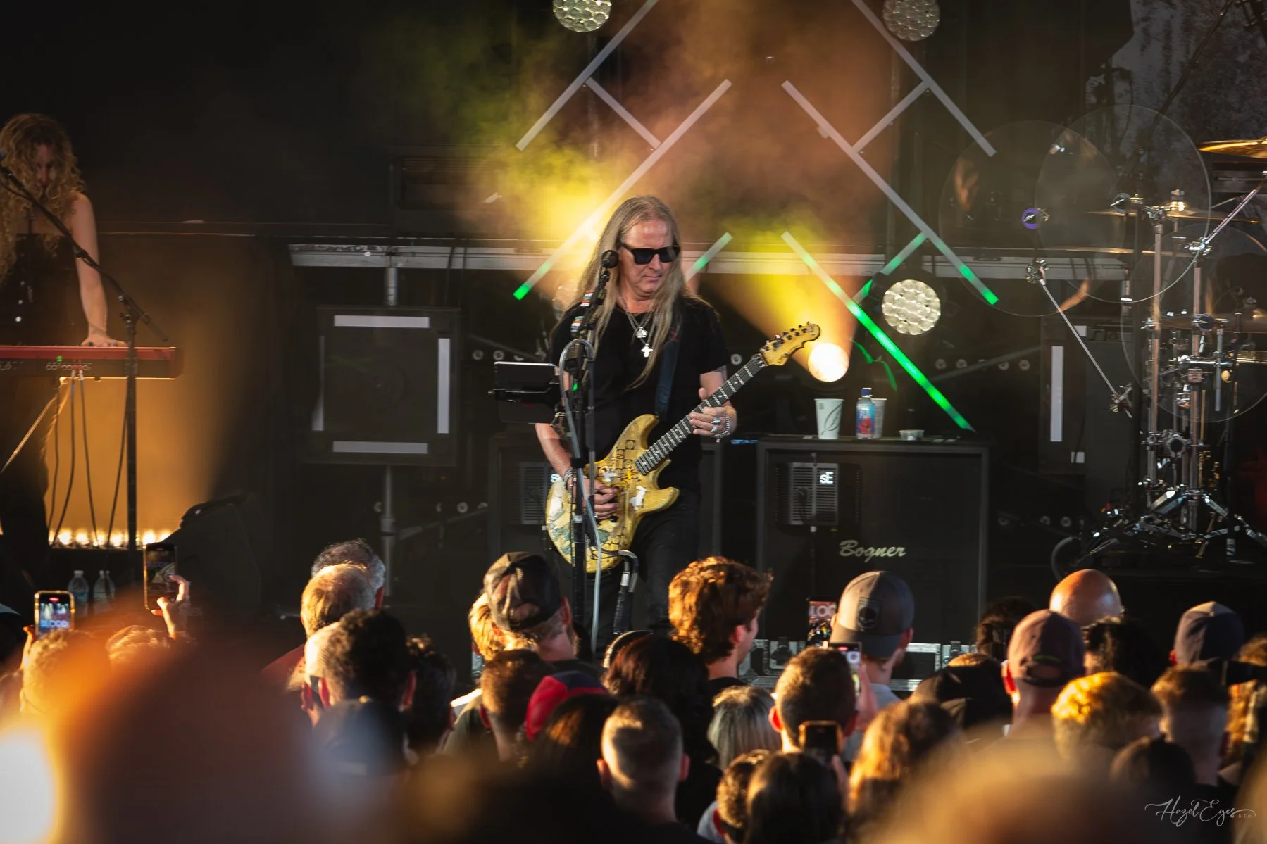 Jerry Cantrell in concert at Michigan Lottery Amphitheatre at Freedom Hill in Sterling Heights, MI on August 16, 2024. Guitarist on stage backlit with bright stage lighting with audience in foreground.