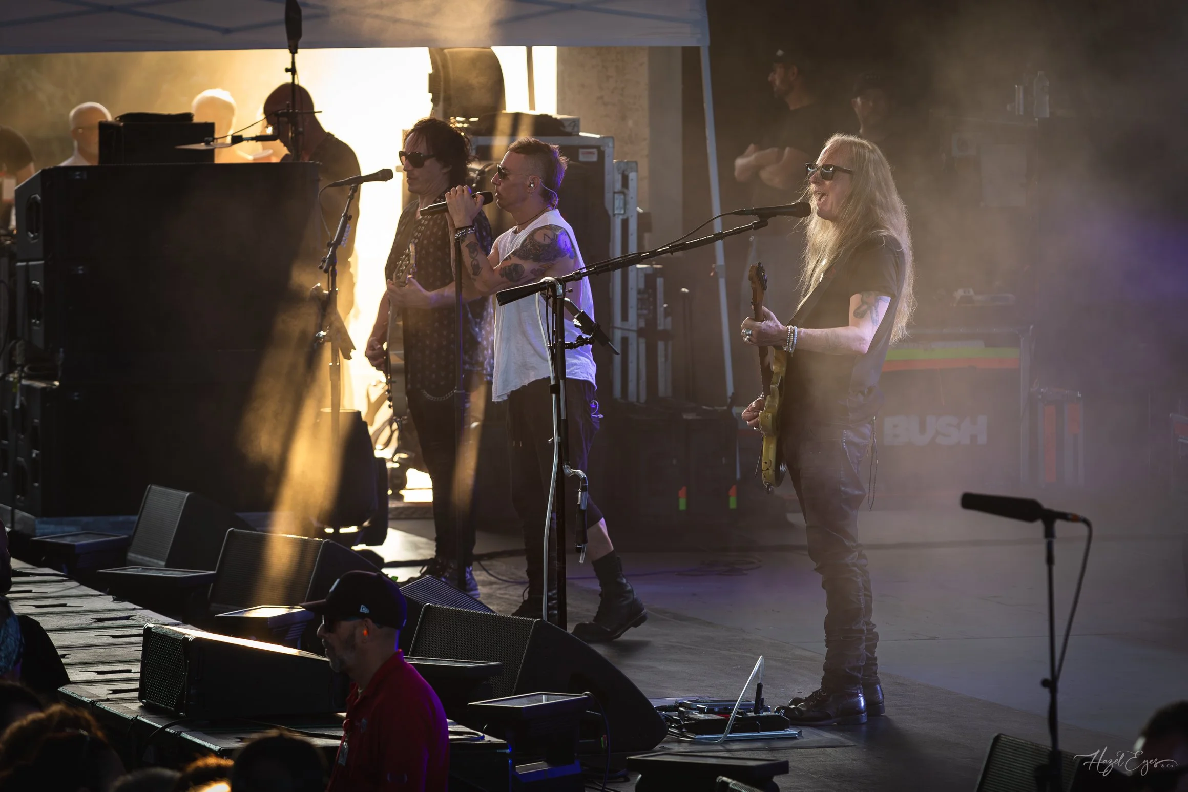 Jerry Cantrell in concert at Michigan Lottery Amphitheatre at Freedom Hill in Sterling Heights, MI on August 16, 2024. Guitarist on stage backlit with bright stage lighting with rays of sun shining on the stage from the side.