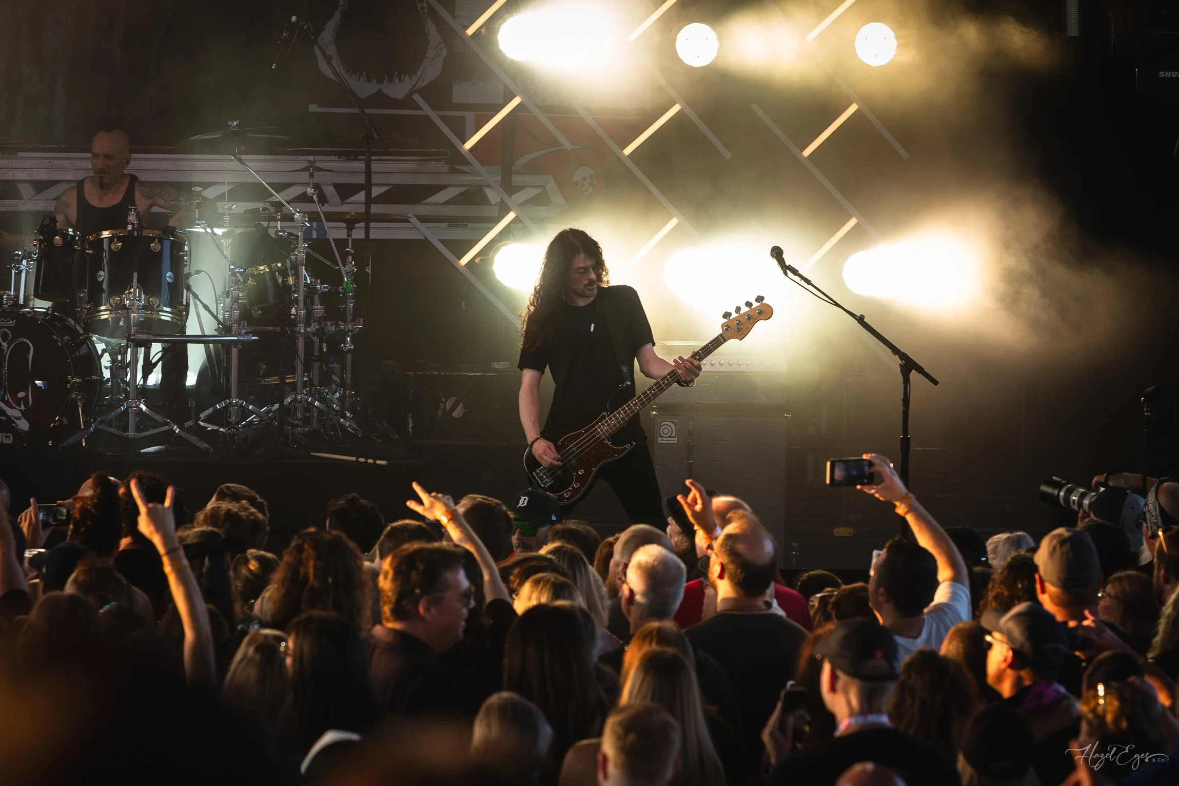Jerry Cantrell in concert at Michigan Lottery Amphitheatre at Freedom Hill in Sterling Heights, MI on August 16, 2024. Guitarist on stage backlit with bright stage lighting with audience in foreground.