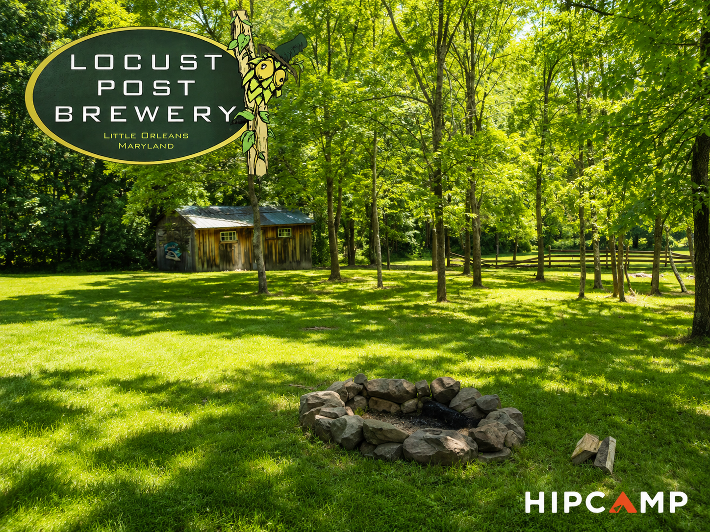 A lush green grassy area with trees, a small wooden shed, and a fire pit made of rocks. A sign reads 'Locust Post Brewery Little Orleans Maryland' with a hop cone illustration. The scene is sunlit with shadows of trees on the grass.