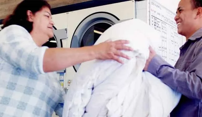 Laundry attendant washing the laundry items
