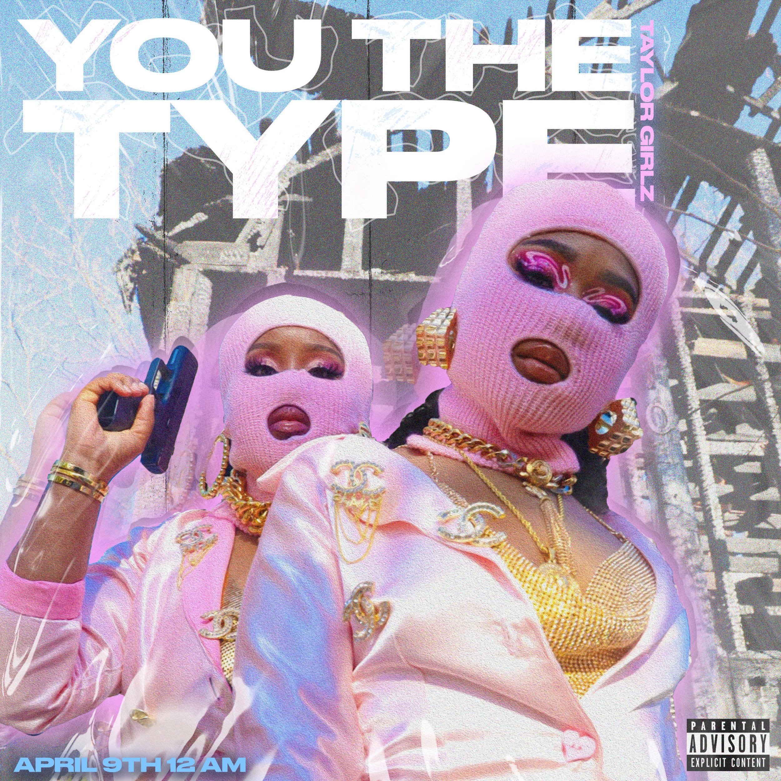 Two women wearing pink ski masks and gold fashion accessories, posing outdoors under a metal structure with a blue sky in the background. The image features bold white text that reads 'YOUTUBE THE TYPES' and smaller pink text 'TAYLOR GIRLZ'. The bott