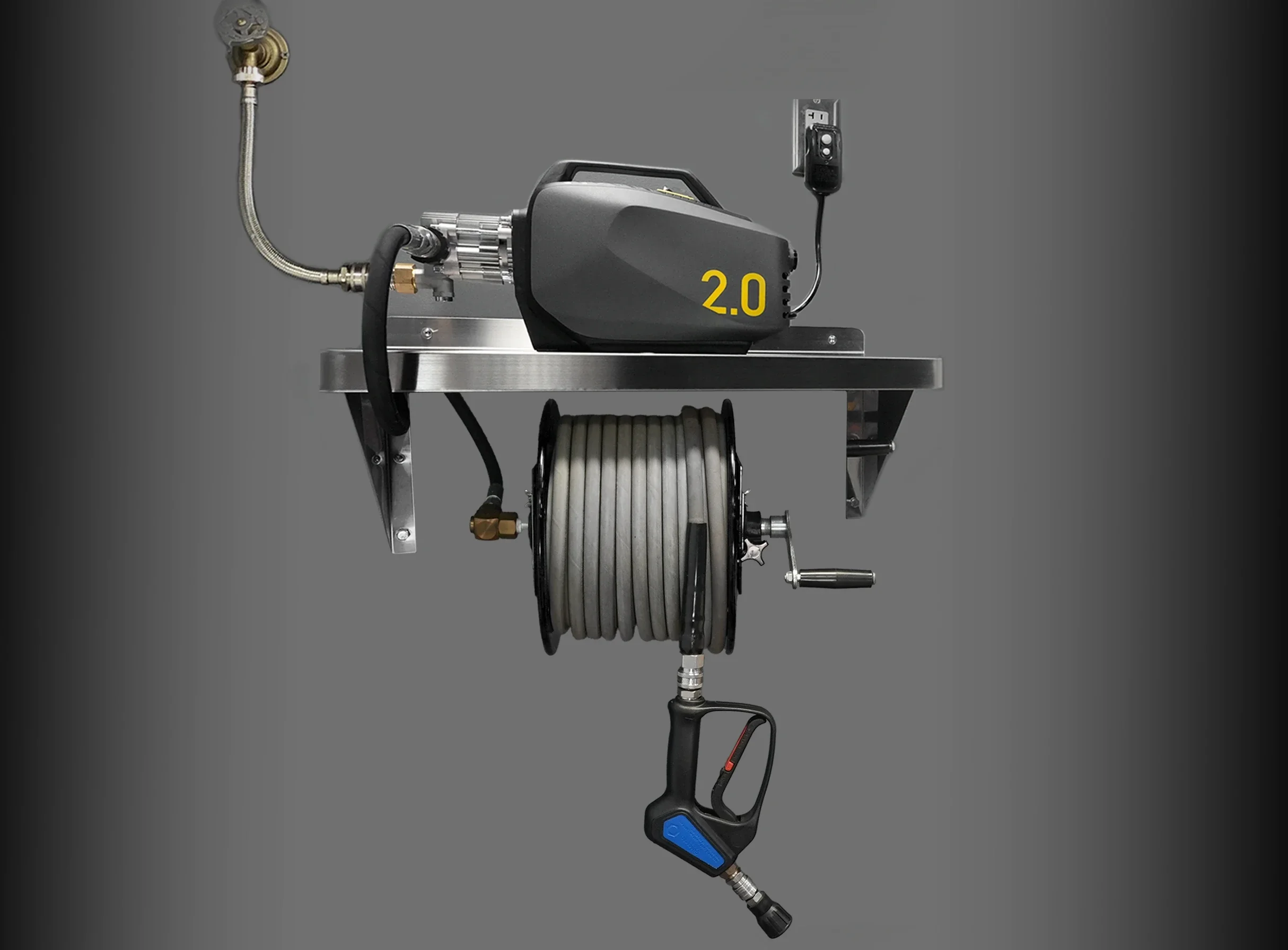 A mechanical device with a black casing labeled '2.0', various metal pipes and connectors, a large coiled gray hose, electronic components, and a handle with a blue lever, mounted on a metallic stand.