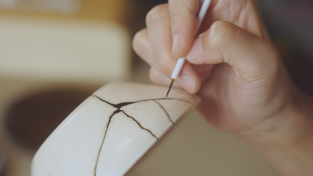 close up of a hand working on Kintsugi as a therapeutic activity