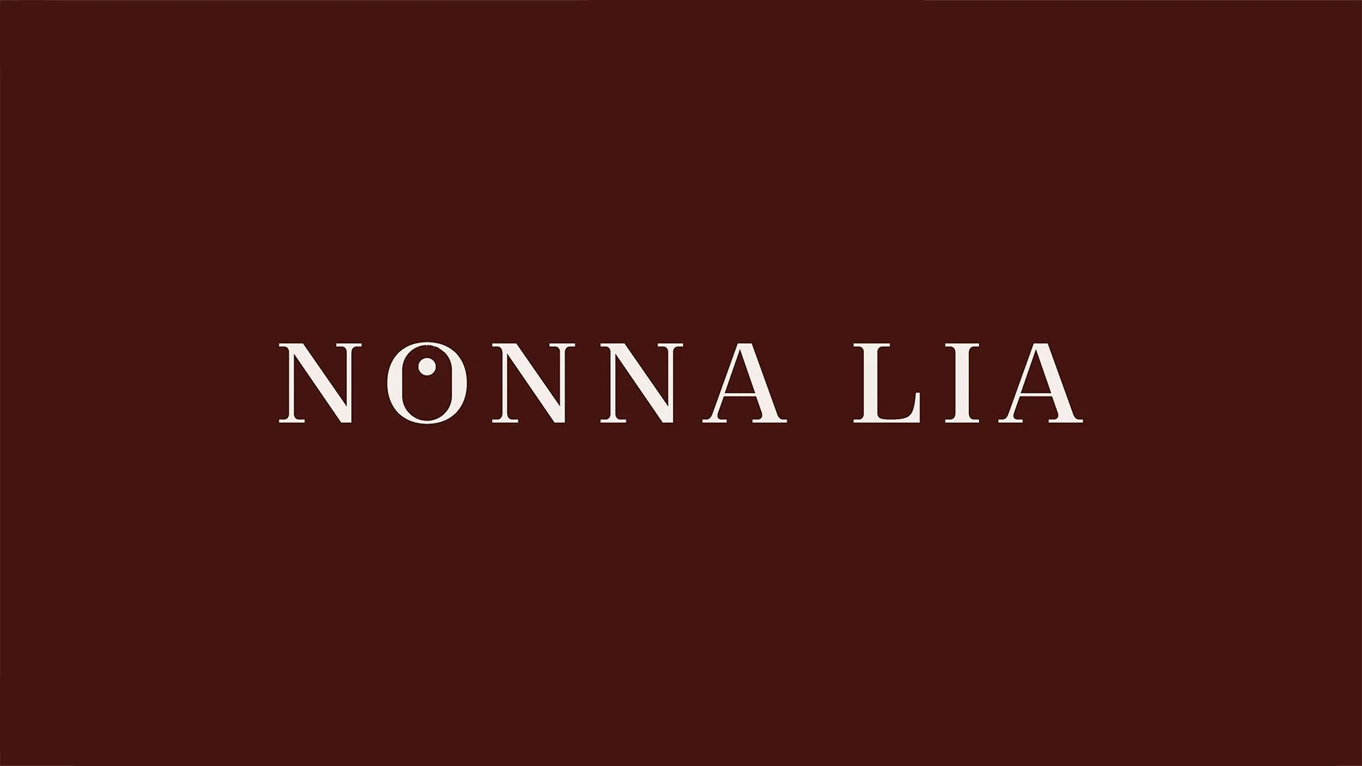 Text reading 'NONNA LIA' on a dark red background.